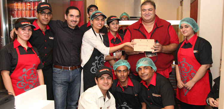 Ali Naeem with the Cold Stone Creamery Team